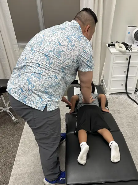 Gene Xiong Adjusting A Young Boy