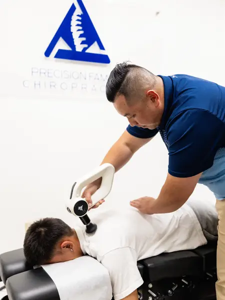 Gene Xiong Using A Tool on a patients back.